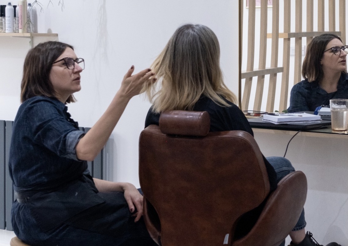 Nancy Stripe in consultation with a client, discussing hair colour options, grey blending and the specialist hair techniques used at Stripe Colour Studio.